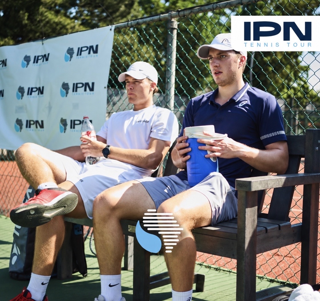 Two IPN Tennis Tour players seated courtside